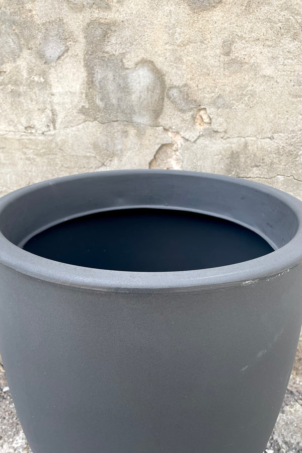 An over-the-lip view of the 20" Porto Planter in Grigio against a concrete backdrop