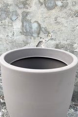 An over-the-lip view of the 20" Porto Planter in Taupe against a concrete backdrop