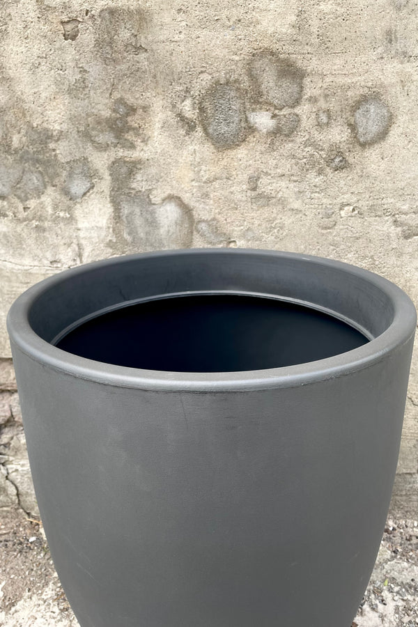 An over-the-lip view of the 24" Porto Planter in Grigio against a concrete backdrop