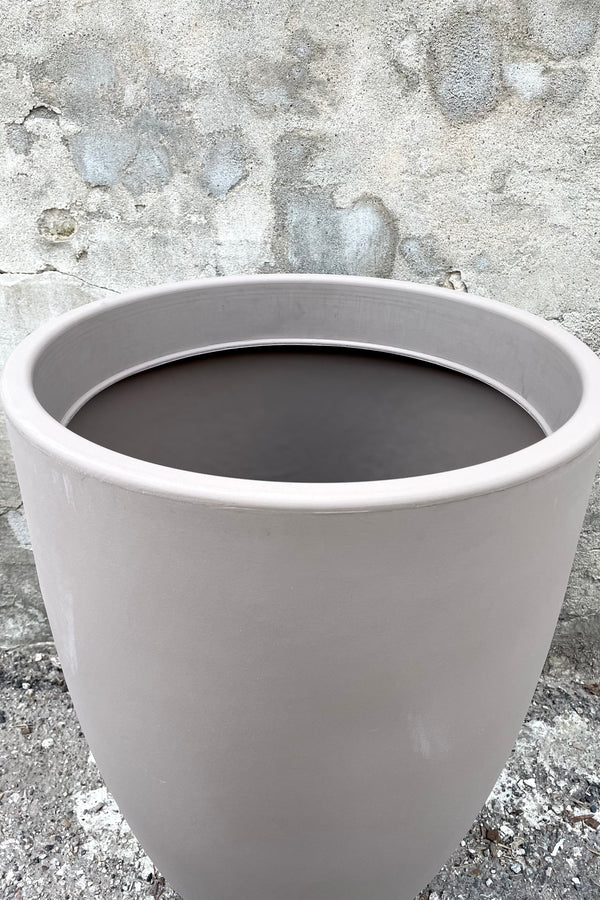 An over-the-lip view of the 24" Porto Planter in Taupe against a concrete backdrop