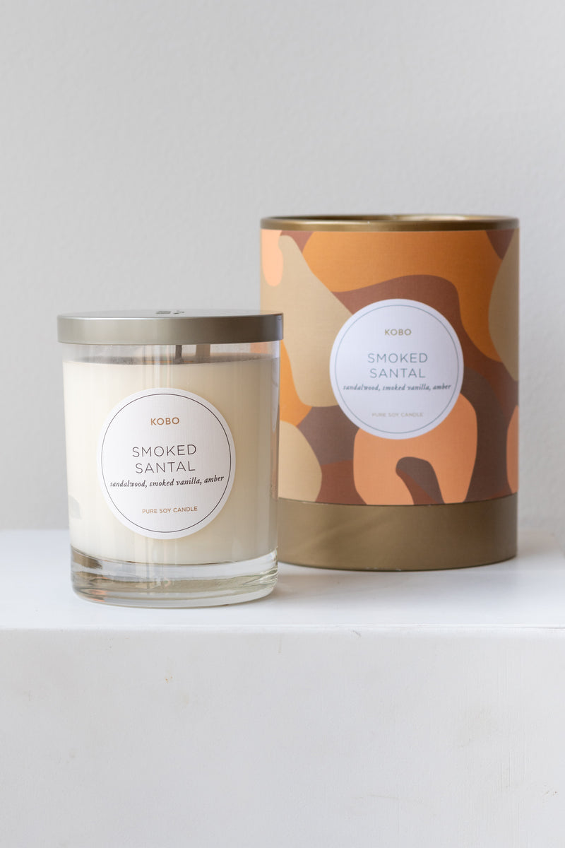 Kobo Candle smoked santal on a white surface in a white room