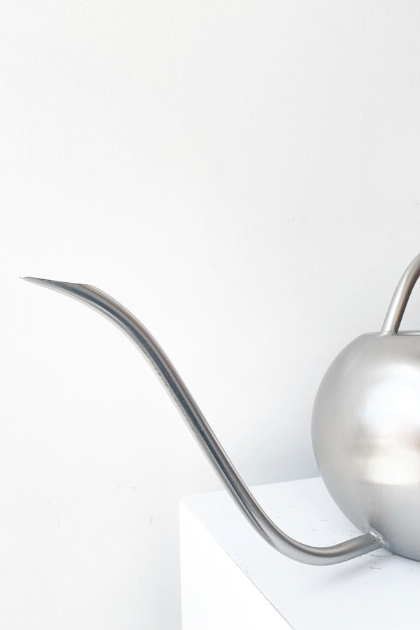 A detailed look at the spout of Watering Can stainless steel against white backdrop