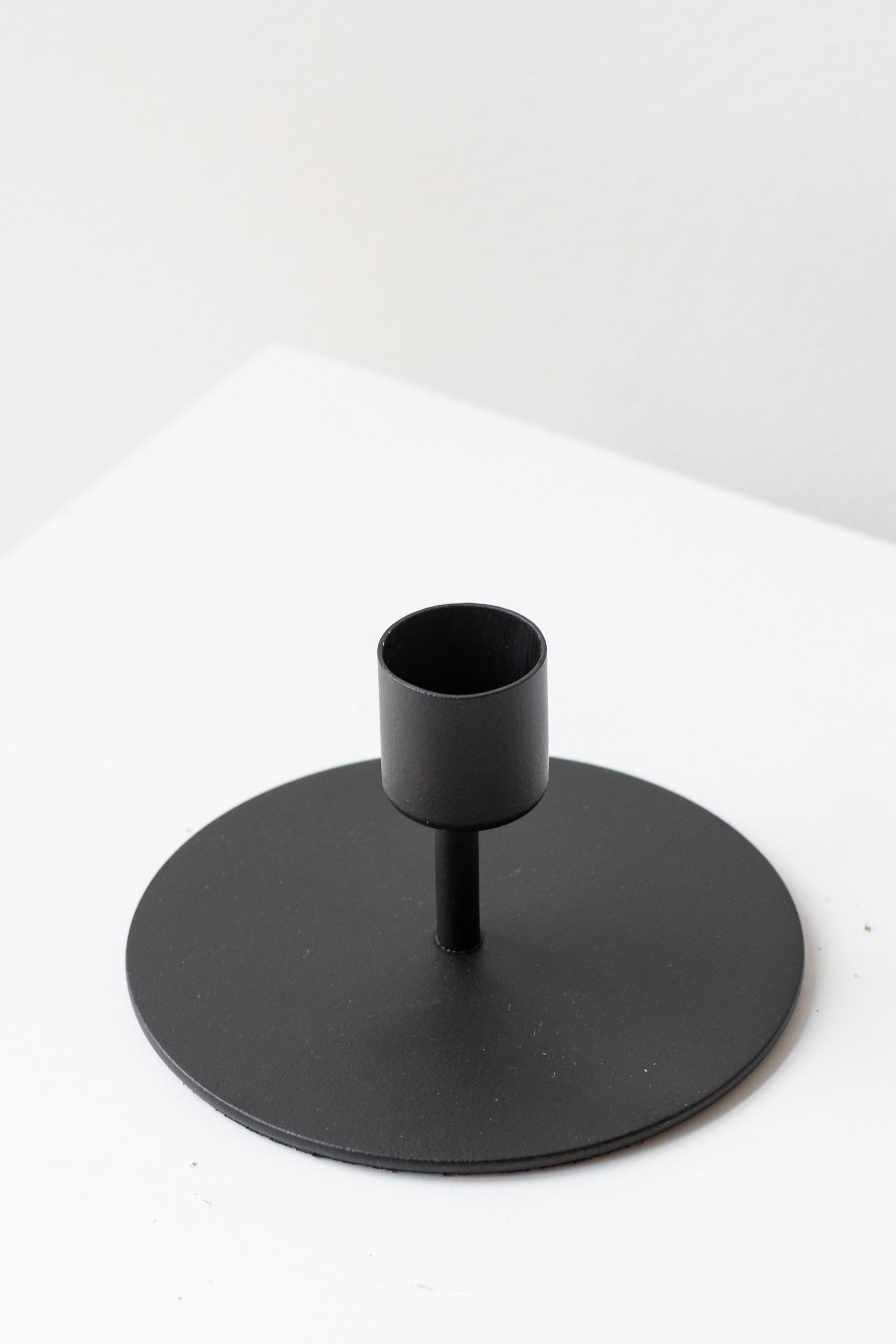 black short Kent metal taper candle holder shown from top side empty on white ©Sprout Home 