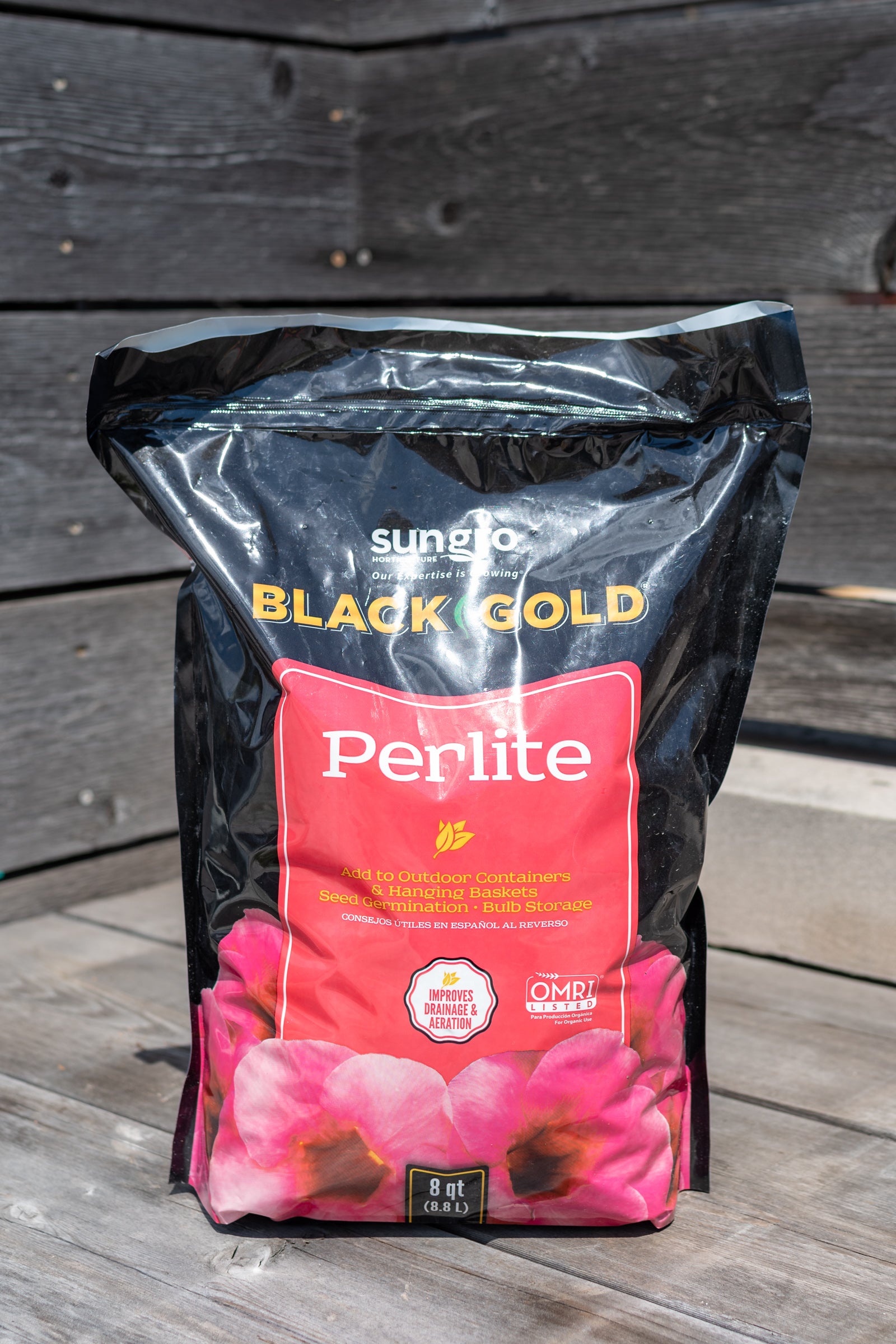 8qt Black Gold Perlite bag in front of grey wood