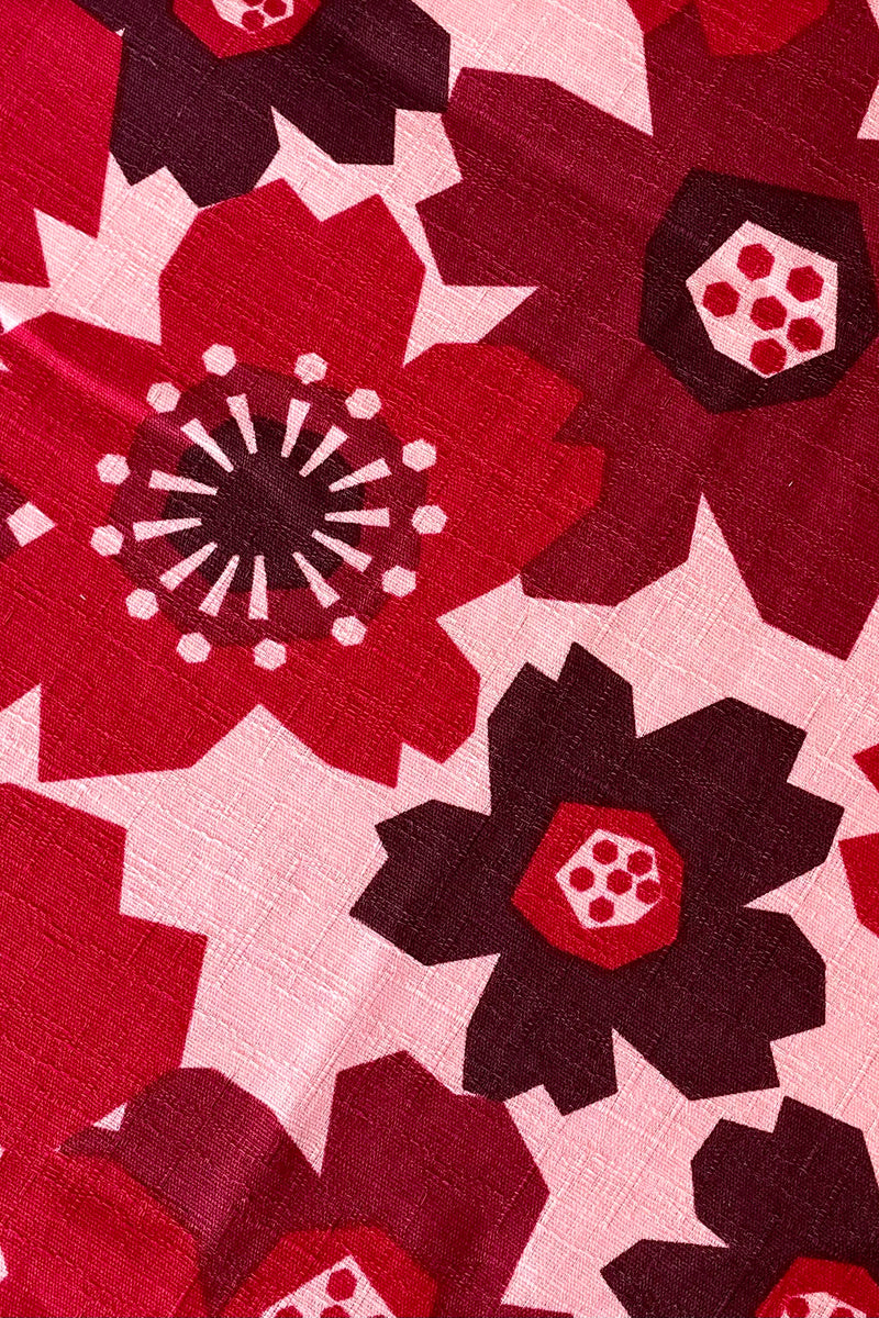 A detailed view of the pattern of the Furoshiki Pattern Flowers Red 42" Square