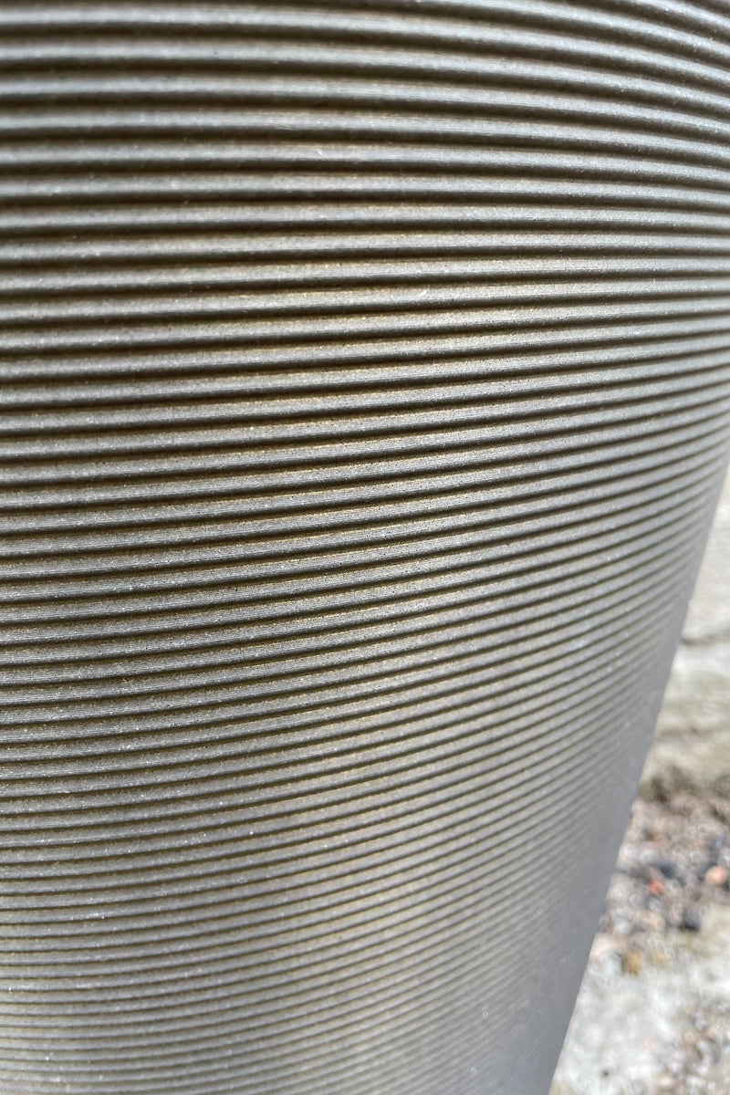a detail picture of the horizontal banding on the old bronze madison pot. 