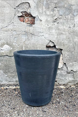 Madison Caviar Black 14" by Crescent Trading in front of concrete wall