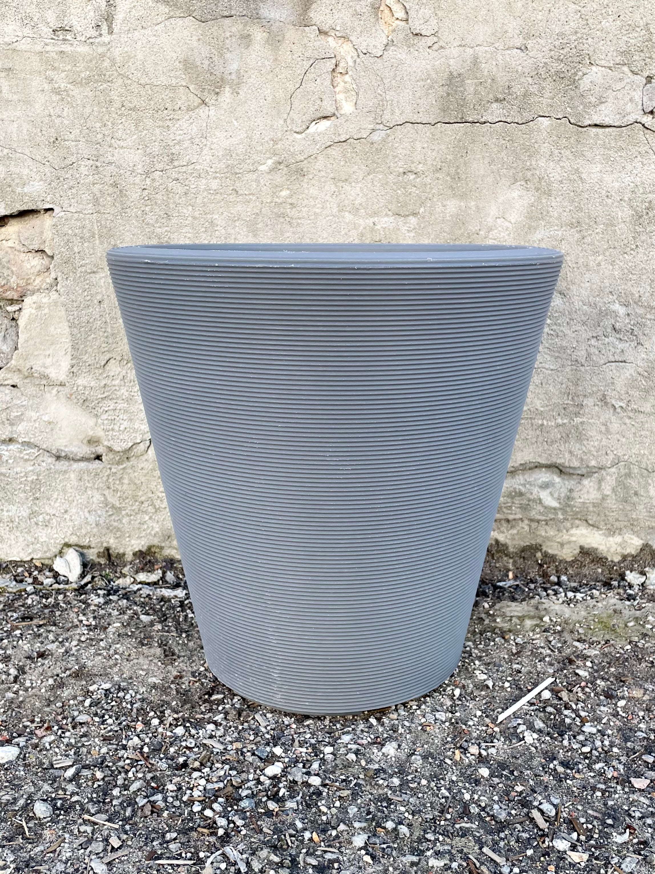 14" slate Madison planter against a concrete wall.