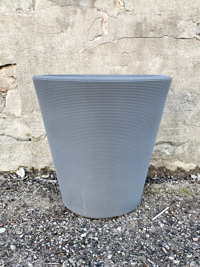 14" slate Madison planter against a concrete wall.