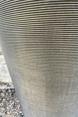 A detail shot of the horizontal ridges of the old bronze madison planter. 