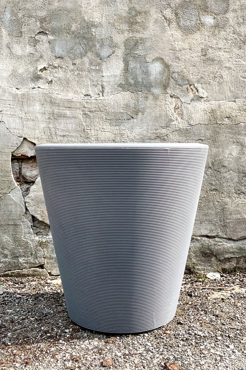 Madison Slate Planter 16" by Crescent Trading in front of concrete wall