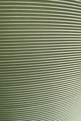 A close up picture of the horizontal ridges of the olive madison planter. 