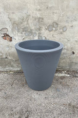 The 26" Slate Madison Slate planter against a cement wall. 