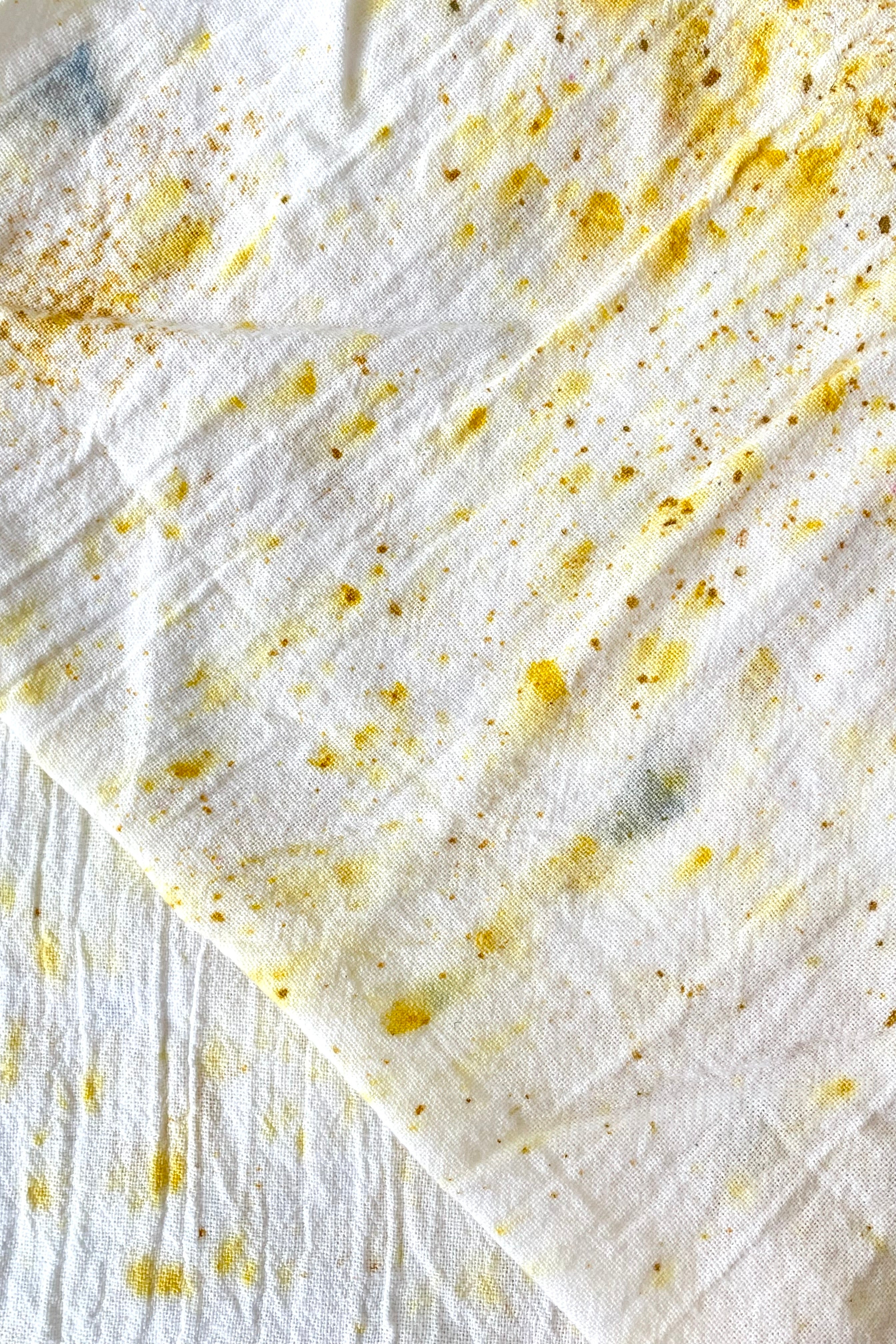 A close-up view of the Botanically Dyed Tea Towel in abstract yellow 