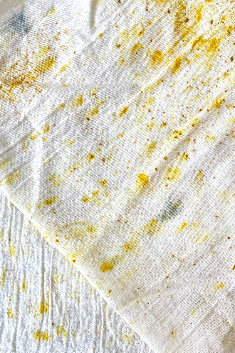 A close-up view of the Botanically Dyed Tea Towel in abstract yellow 