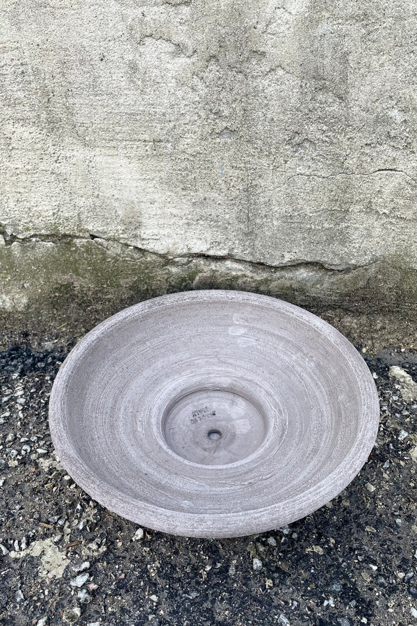 An overhead view of Ada Clay Bowl & Saucer grey 30cm against concrete backdrop
