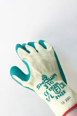 A hand dons Atlas Super Grip Gloves Large against white backdrop
