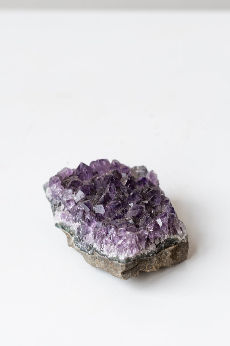 Amethyst cluster on white surface