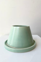 Verdigris Anthony planter against a white wall at Sprout Home.