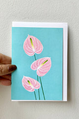 Anthuriums greeting card by stengun being held against a white wall with the envelope inside