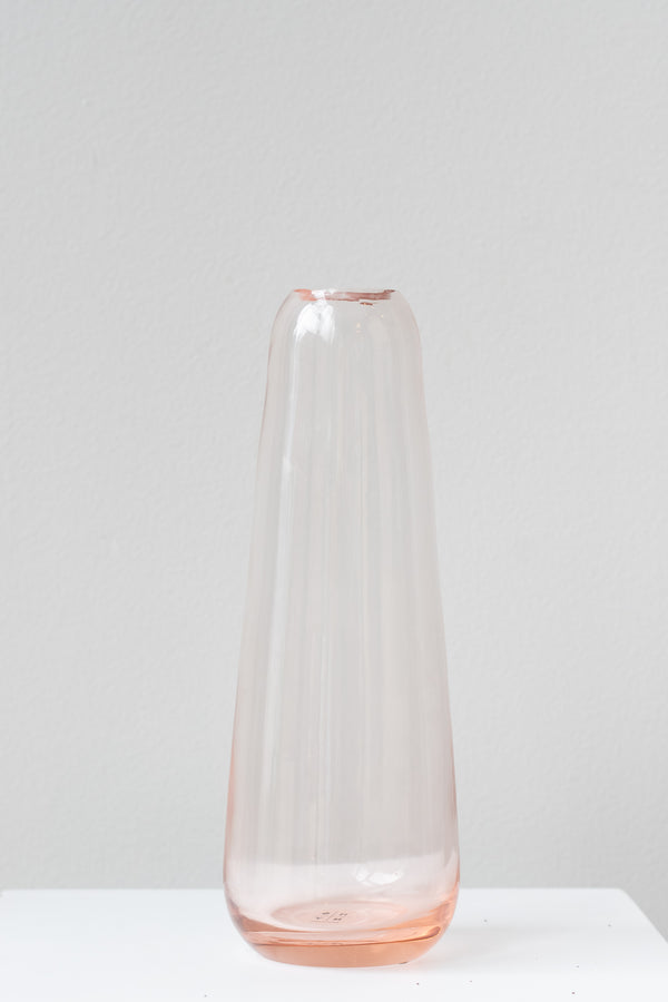 Hawkins New York blush Aurora slim drop vase in front of white background
