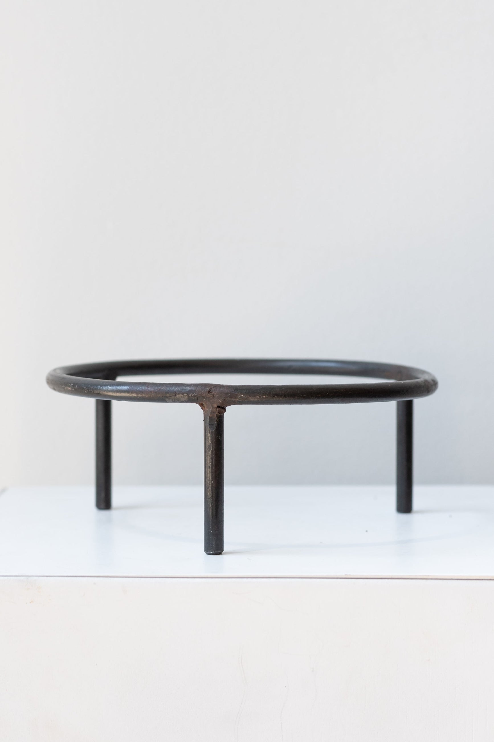 6 inch iron metal tripod pot stand on a white surface in a white room ©Sprout Home