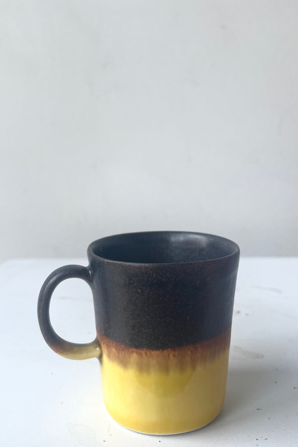 A frontal full view of Espresso cup black & golden glaze against white backdrop