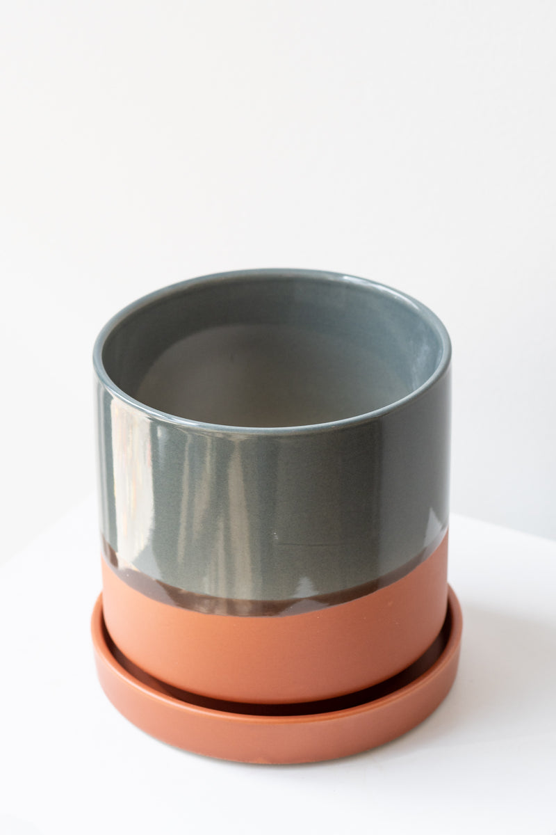 Large Terracotta Minute Pot sits on a white surface in a white room