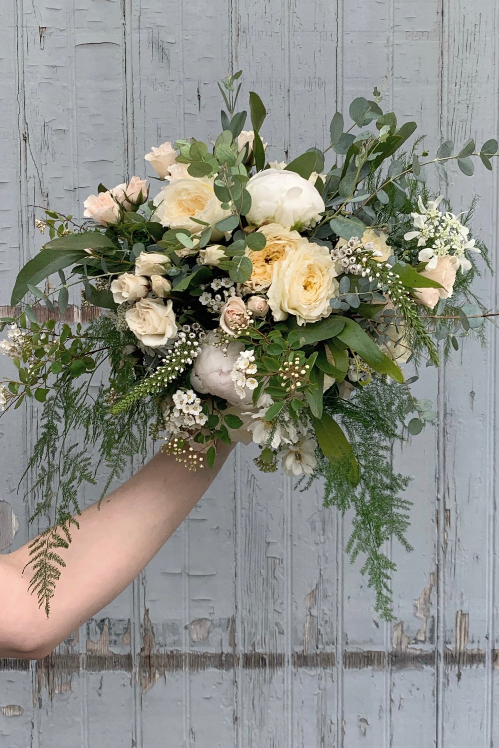 An example of Floral Arrangement Bleached by Sprout Home in Chicago. The arrangement uses primarily white flowers with green foliage.©Sprout Home #size_$130
