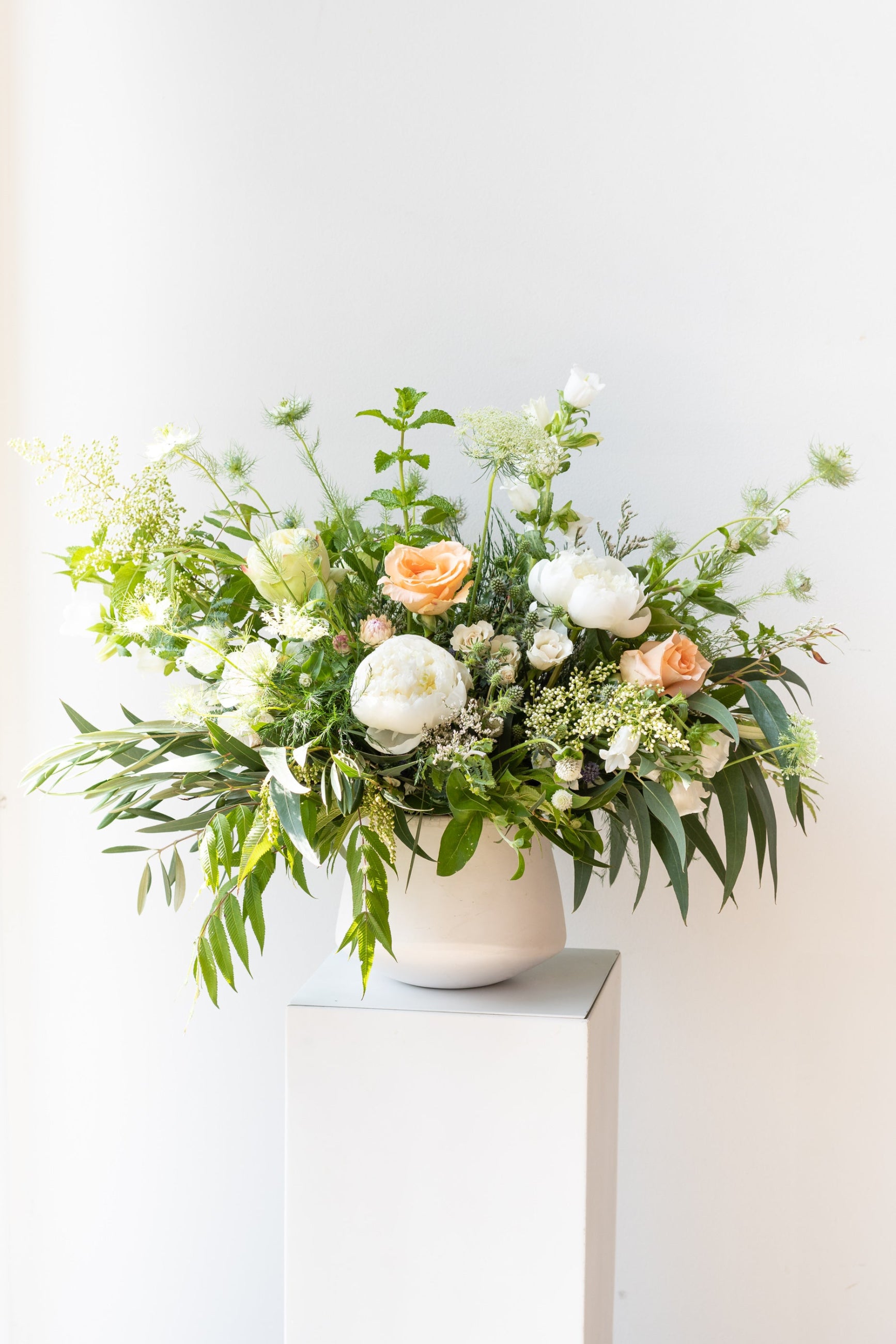An example of Floral Arrangement Bleached by Sprout Home in Chicago. The arrangement uses primarily white flowers with green foliage. ©Sprout Home #size_$200