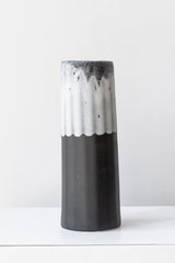 Bloom Vase in Night Snow by The Bright Angle sits on a white surface in a white room