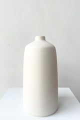 A frontal view of Bud Vase white medium against white backdrop