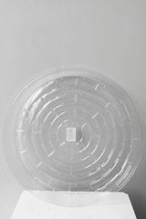A full overhead view of Plastic saucer 12" against white backdrop