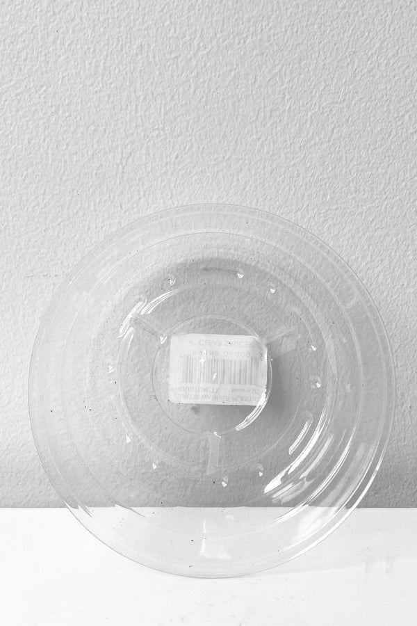 A full overhead view of Plastic saucer 4" against white backdrop