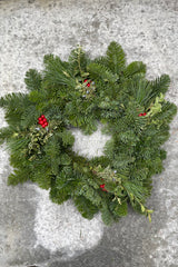 Simple evergreen wreath with pops of faux canella berry and pine. 