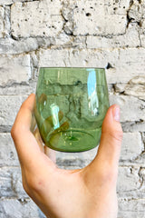 detail of Century Glasses green, 6oz - Set of 2 held against a  grey brick background 