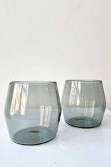 6oz grey century glass pair against a white wall. 