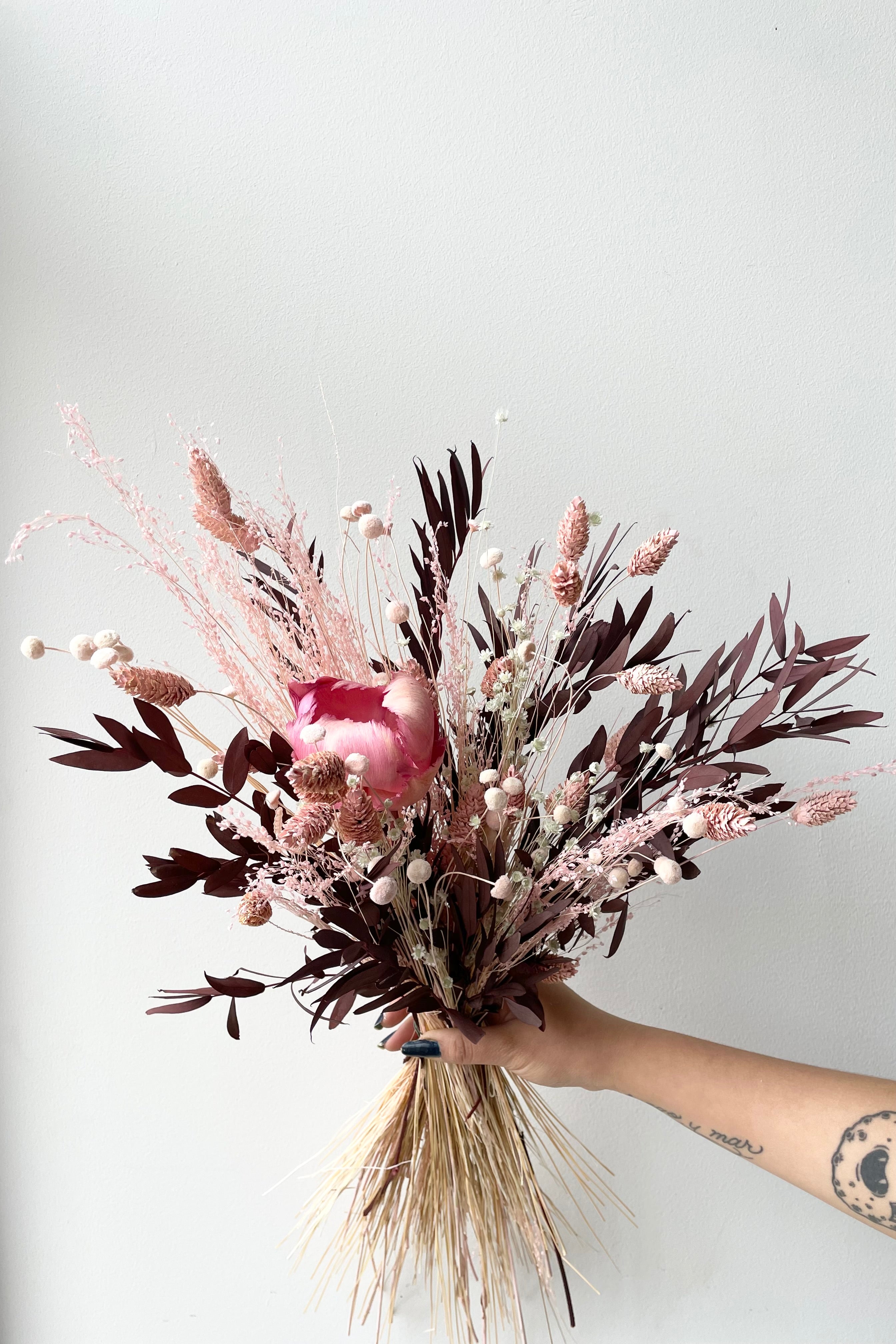 Sprout Home's Chocoberry preserved arrangement against a white wall. #size_$60