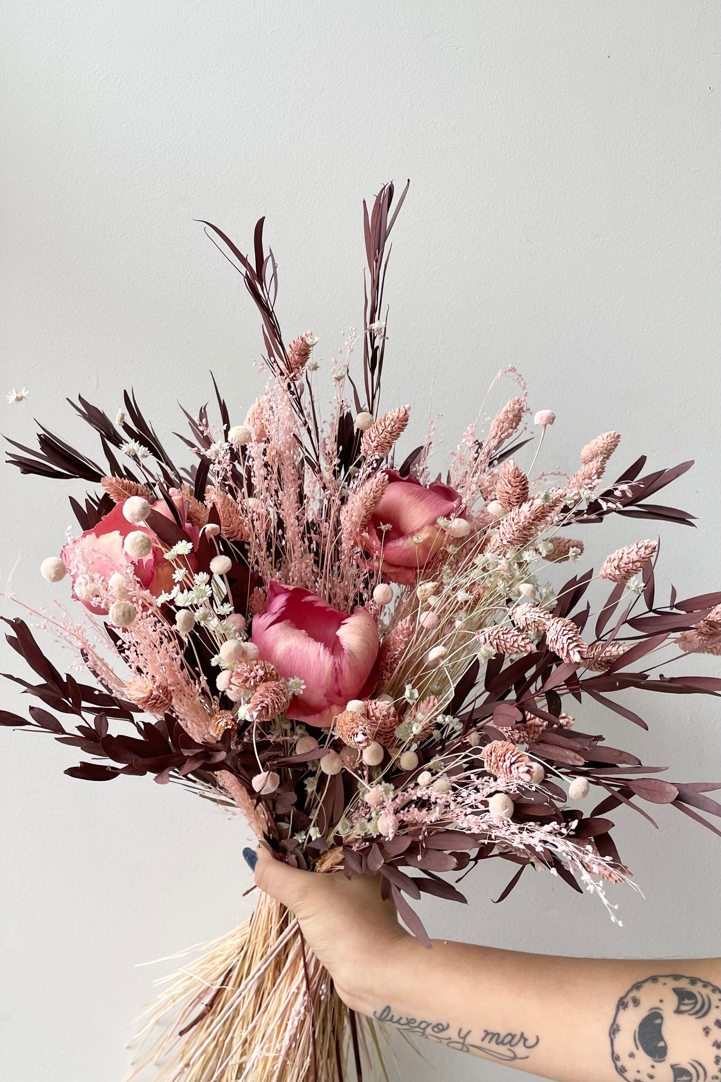 Chocoberry Milkshake preserved arrangement by Sprout Home against a white wall. #size_$125