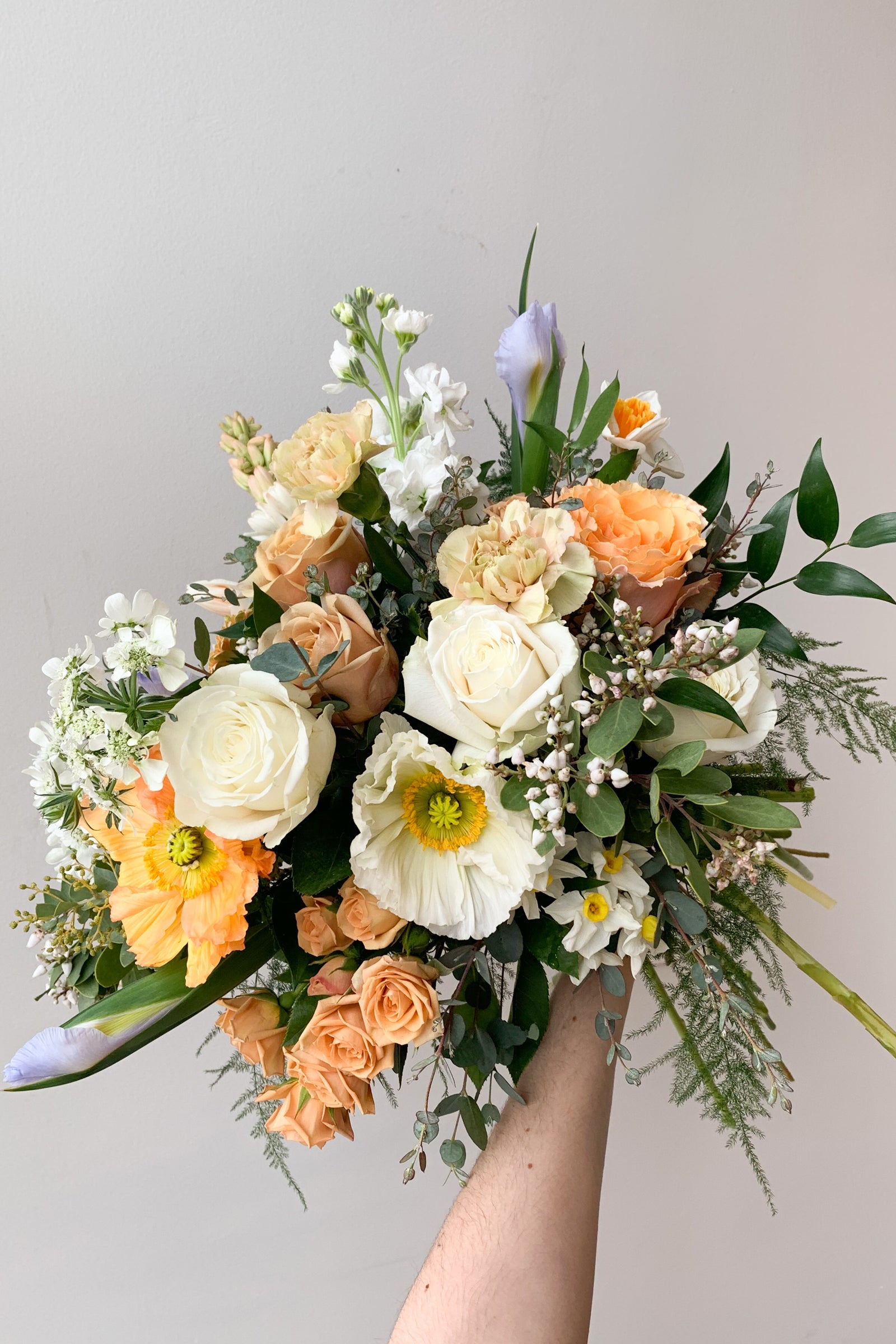 An example of Floral Arrangement Dawn from Sprout Home in Chicago. The arrangement is made of pastel yellow, purple, green, pink, and white flowers with green foliage. #size_$90
