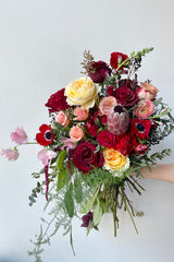 A hand holds an example of fresh Floral Arrangement Modern Love $160 from Sprout Home Floral in Chicago for Valentine's Day