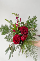A hand holds an example of fresh Floral Arrangement Modern Love $60 from Sprout Home Floral in Chicago for Valentine's Day