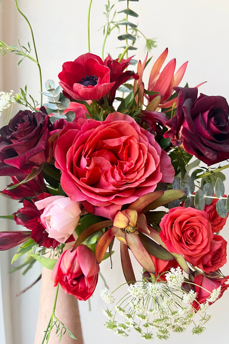 A hand holds an example of fresh Floral Arrangement Modern Love $60 from Sprout Home Floral in Chicago for Valentine's Day