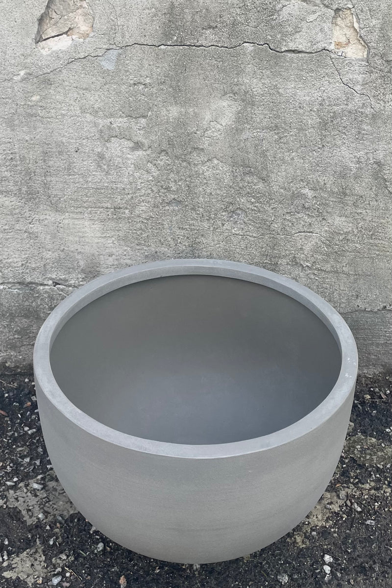 An overhead view of Sunny Bowl Clouded Grey Medium against a concrete backdrop