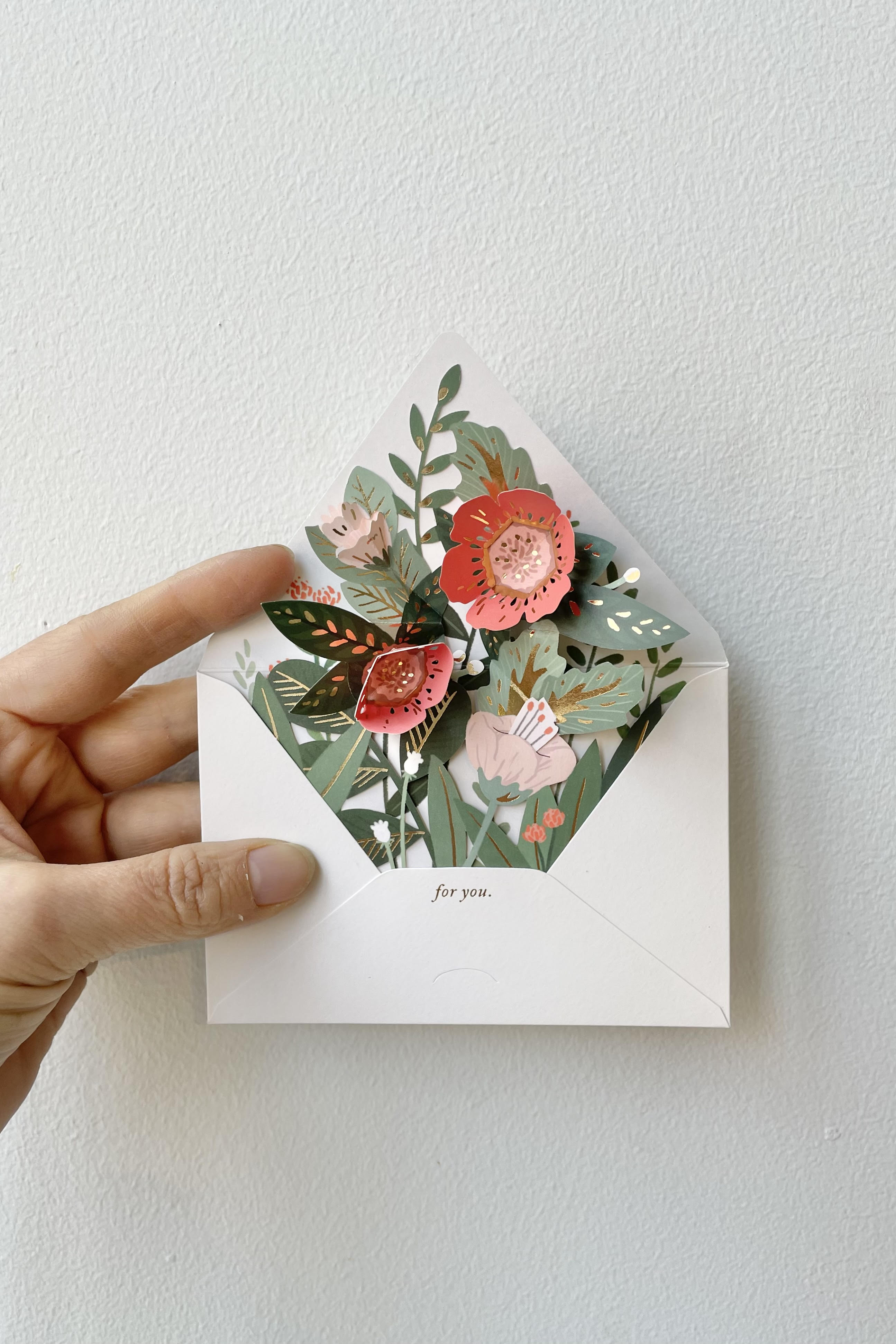 A hand holds open the Floral Pop-up Envelope.