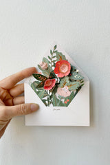 A hand holds open the Floral Pop-up Envelope.