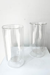A slight overhead view of the set of 2 Clear Double Wall Glass in 16 oz against a white backdrop