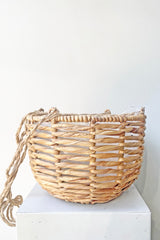 Water Hyacinth Hanging Basket large sits atop a white pedestal