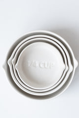 White circular Stoneware Measuring Cup Set nested against a white background