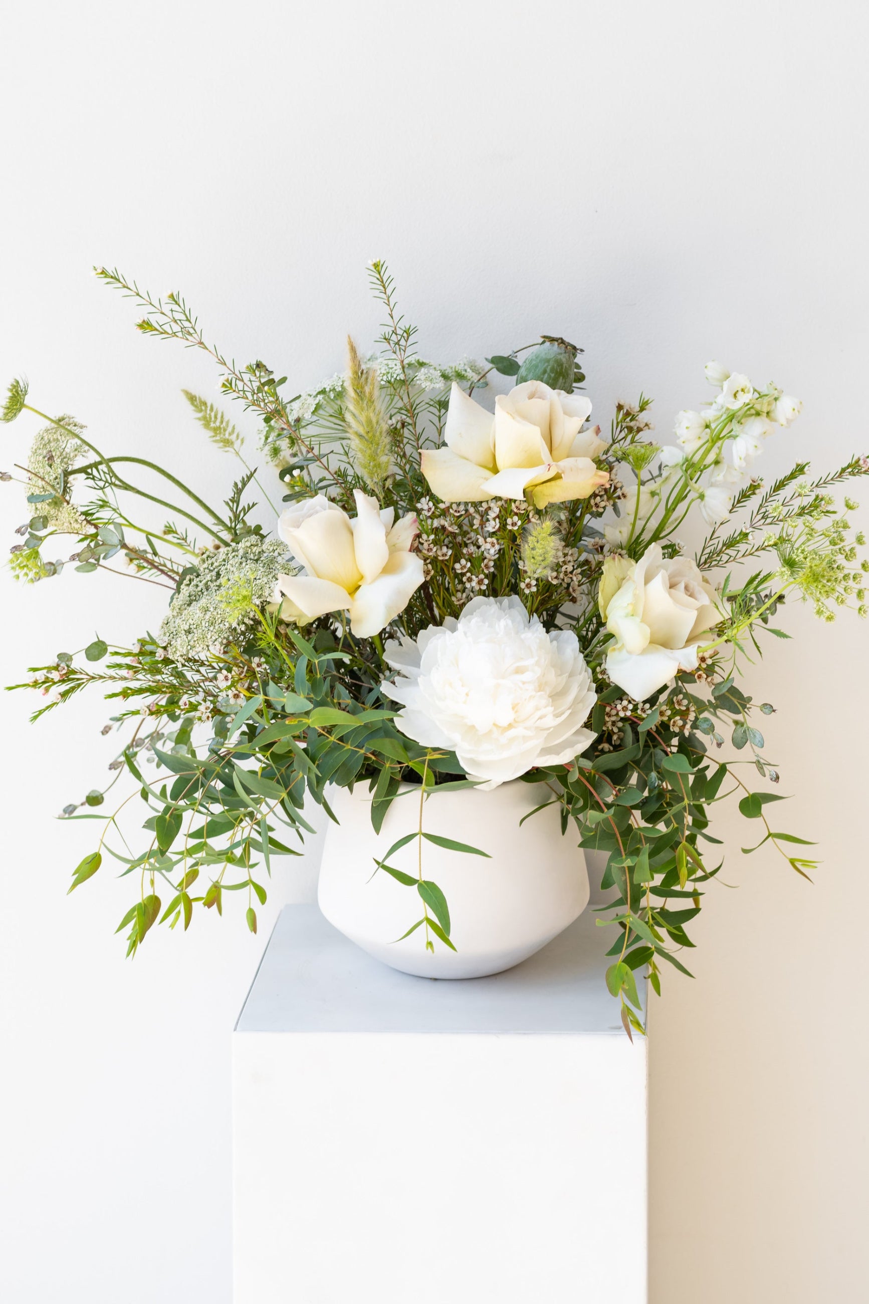 An example of Floral Arrangement Bleached by Sprout Home in Chicago. The arrangement uses primarily white flowers with green foliage.©Sprout Home  #size_$100